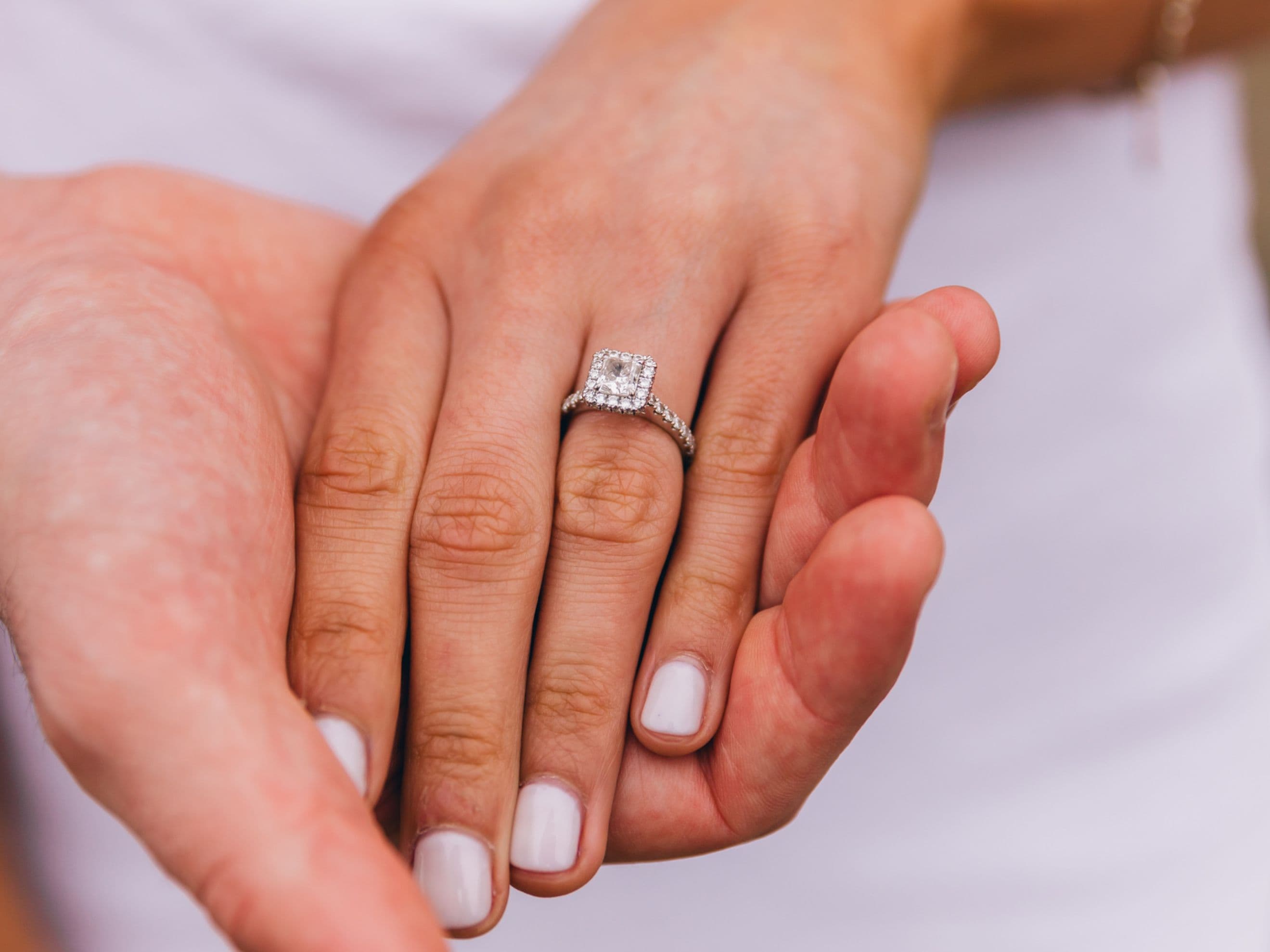 lab grown diamond halo engagement ring being worn